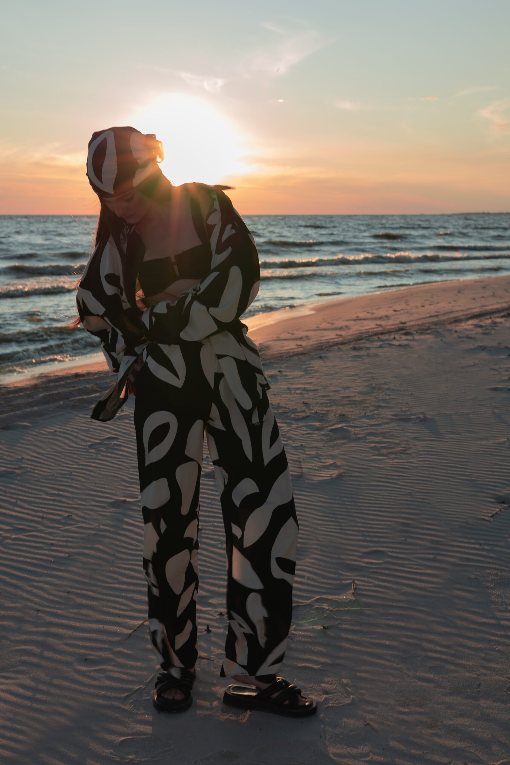 Модель в русі на фоні чорного моря на пляжі в SOLOMIA SUIT черно більного кольору від бренду Her Name